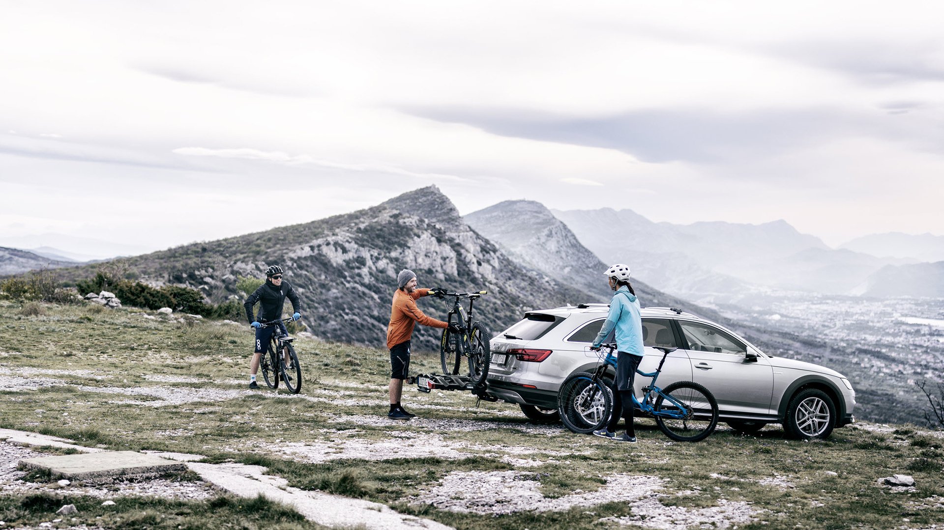 Mountain bikers putting bike on the back of their car