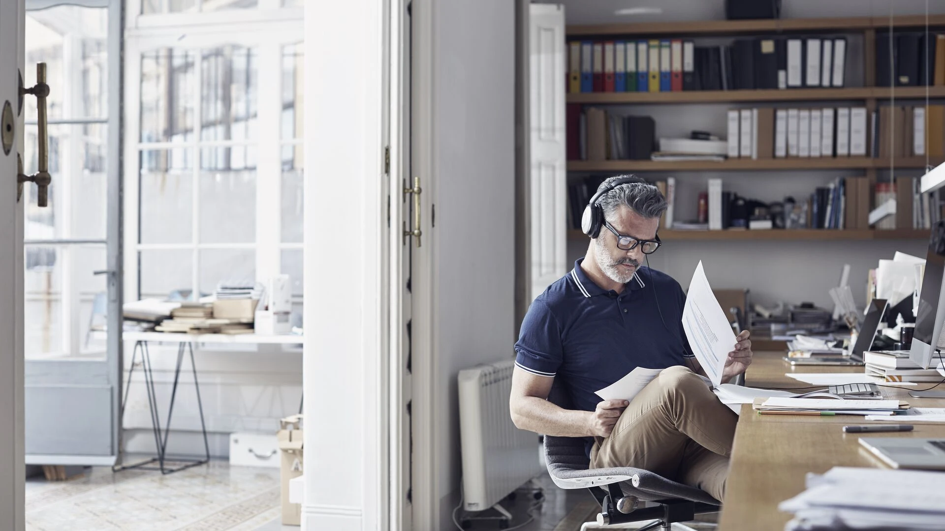Businessman examining documents at desk