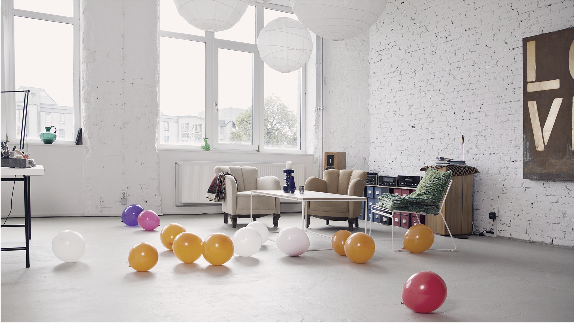 An empty room with balloons on the floor