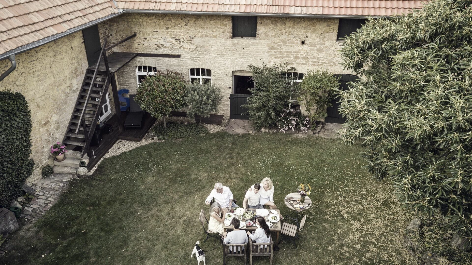 Family eating together in the garden in summer