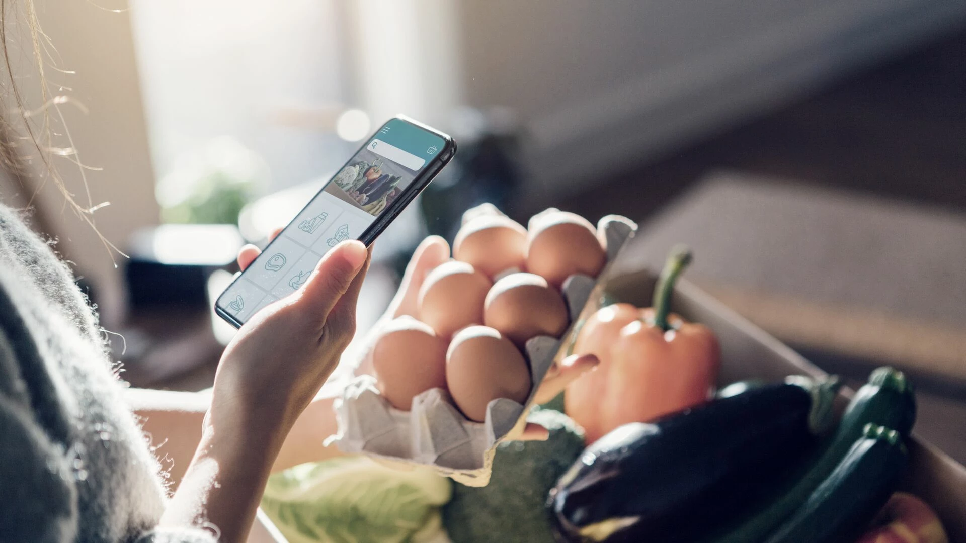young-woman-ordering-groceries-online-with-smartphone.jpg