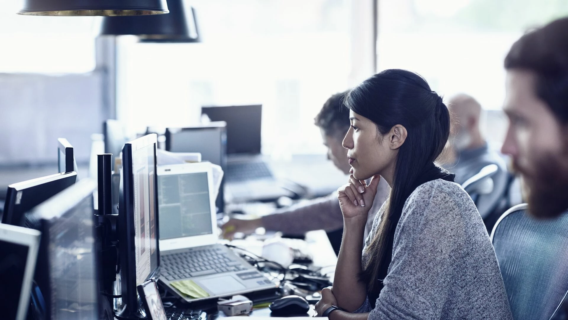 People sitting in front of computers, working in a modern office