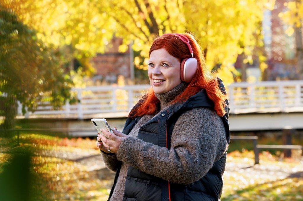 A woman listening to a meeting on mobile