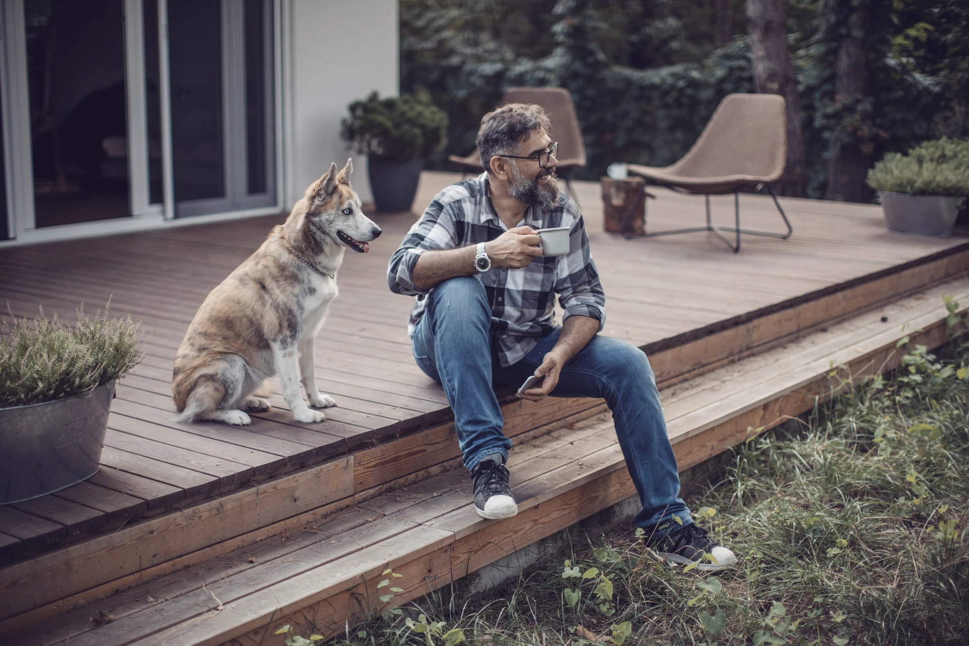 Man sitting on a porch with a dog