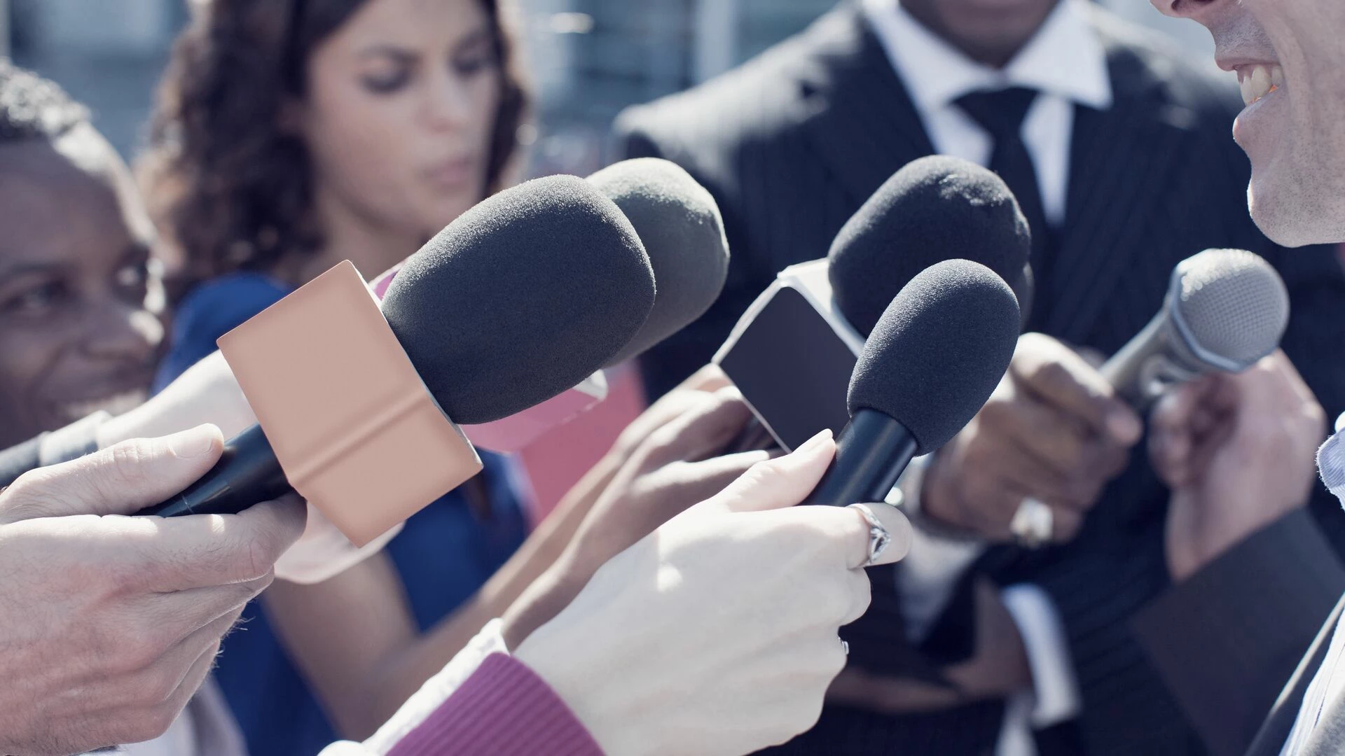 reporters with microphones