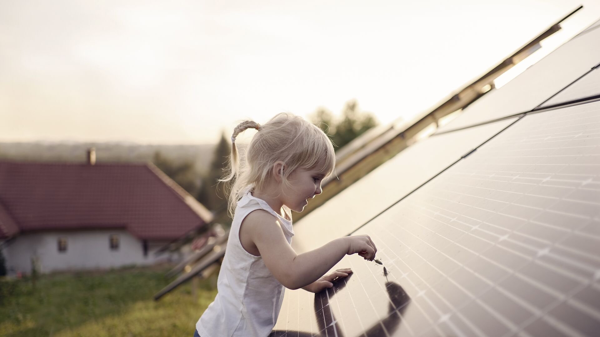 Young girl touching solar panel