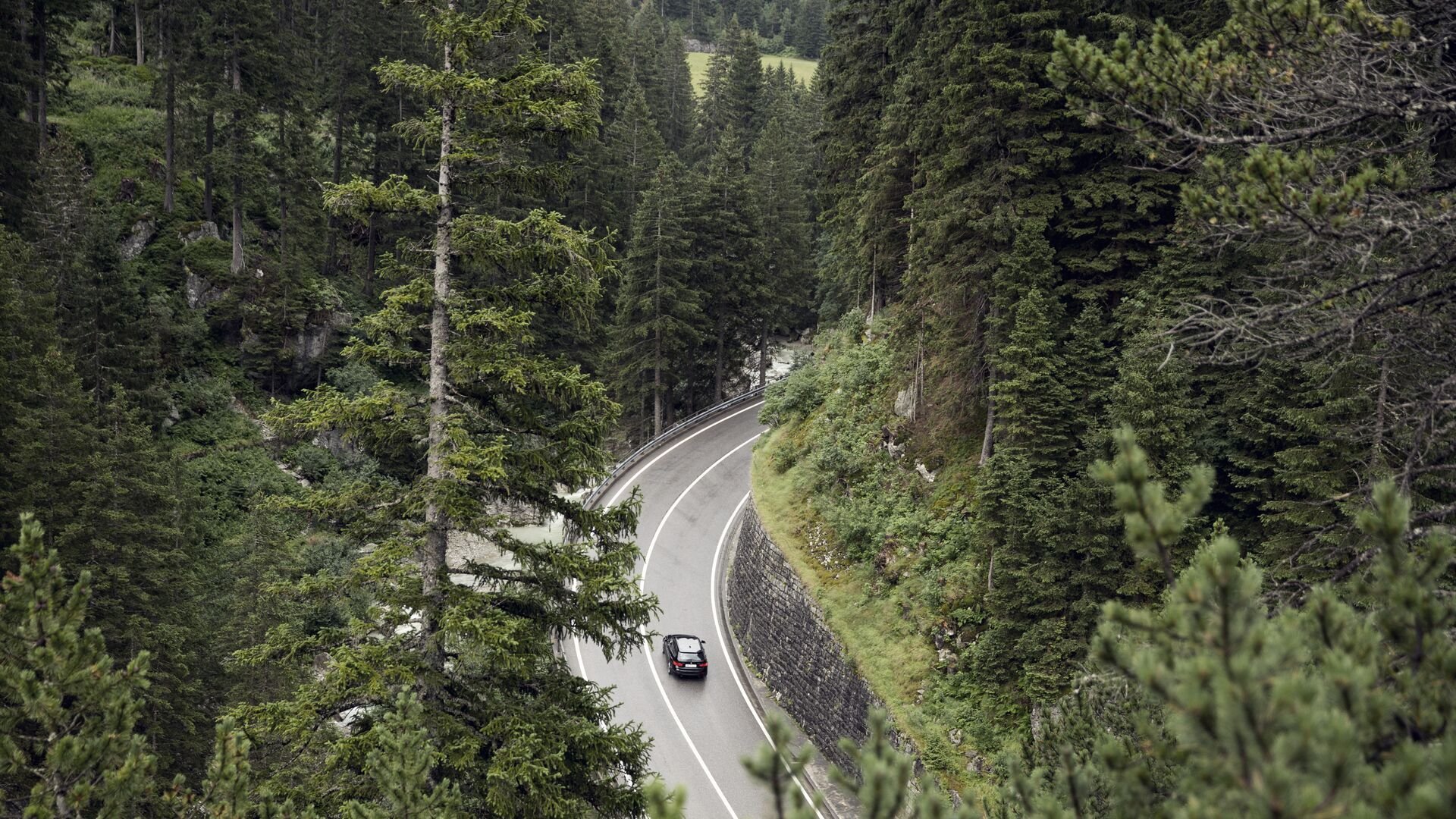 Car in curved road passing through the mountains