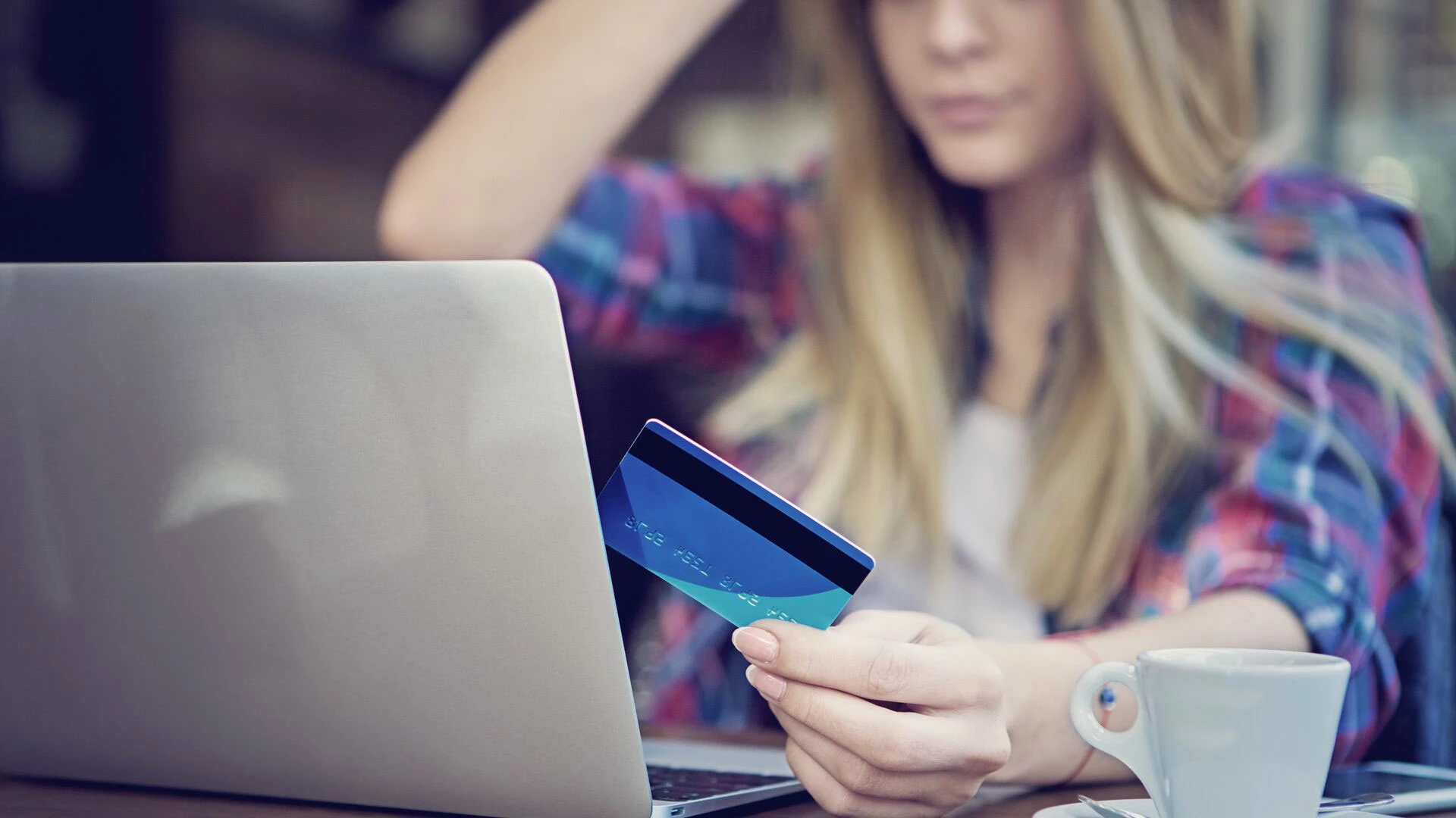 Young girl is shopping online using her credit card