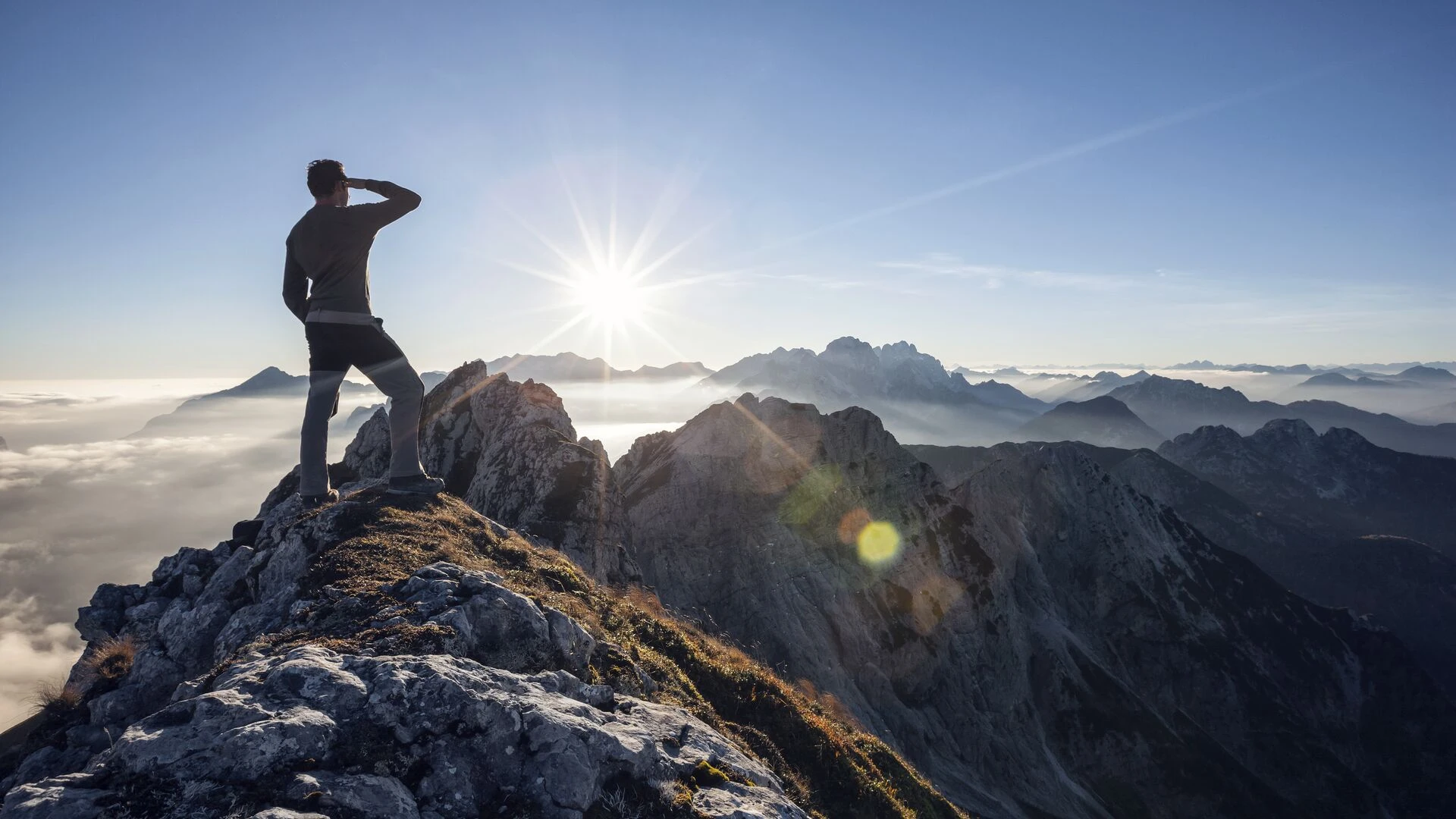 Climber standing on a mountain peak