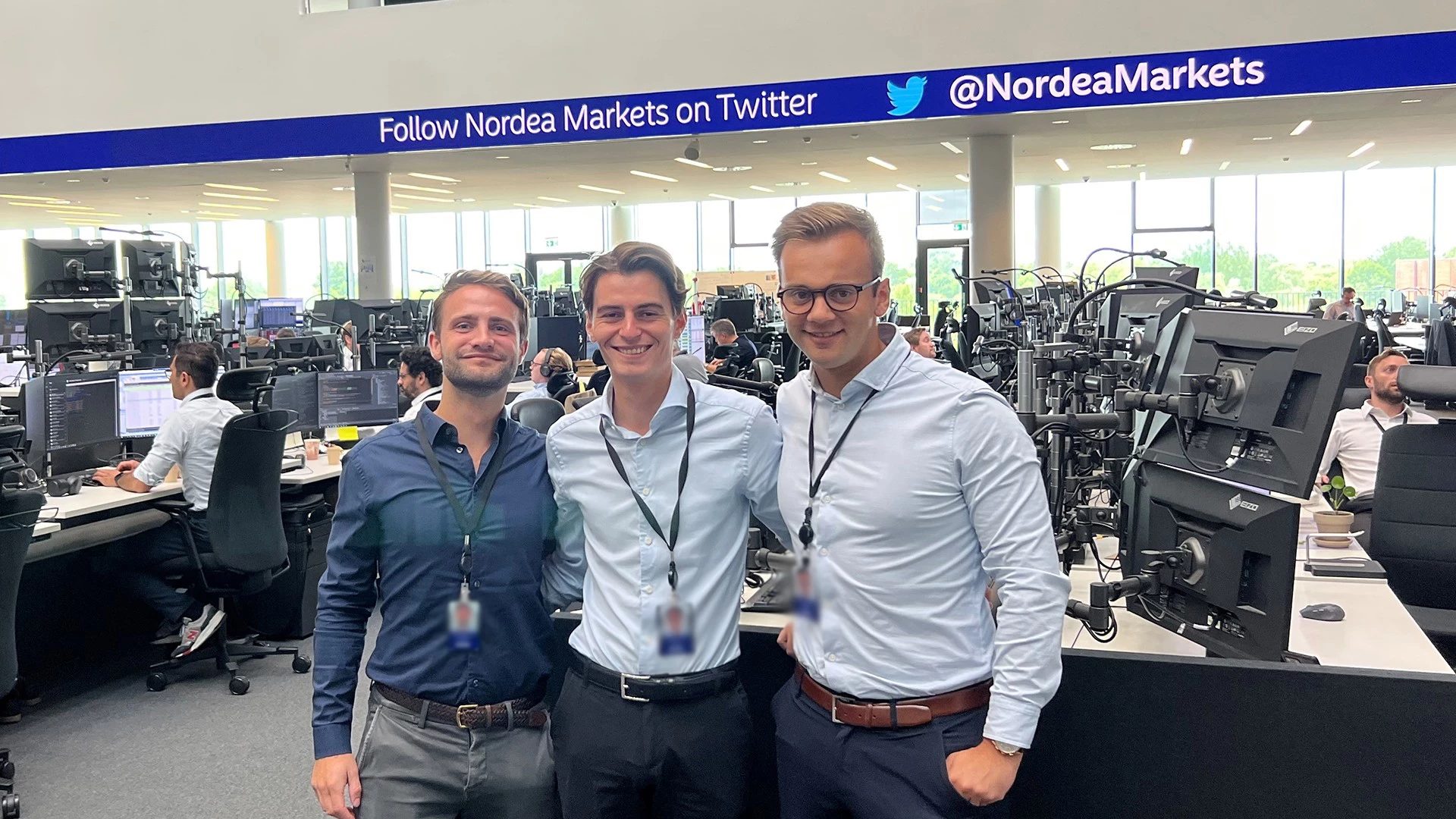 graduates standing on the trading floor