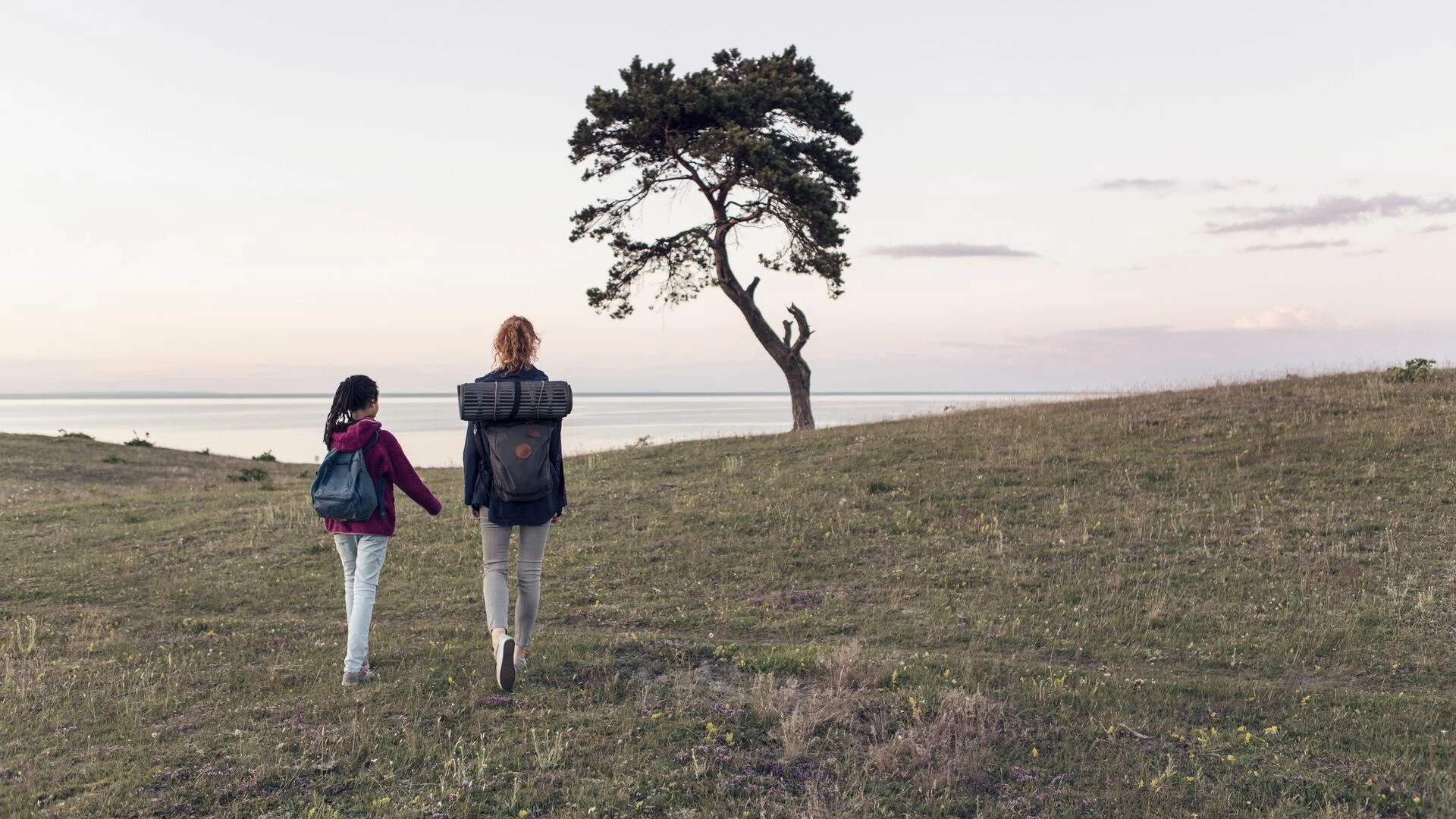 mother-and-daughter-hiking-on-field