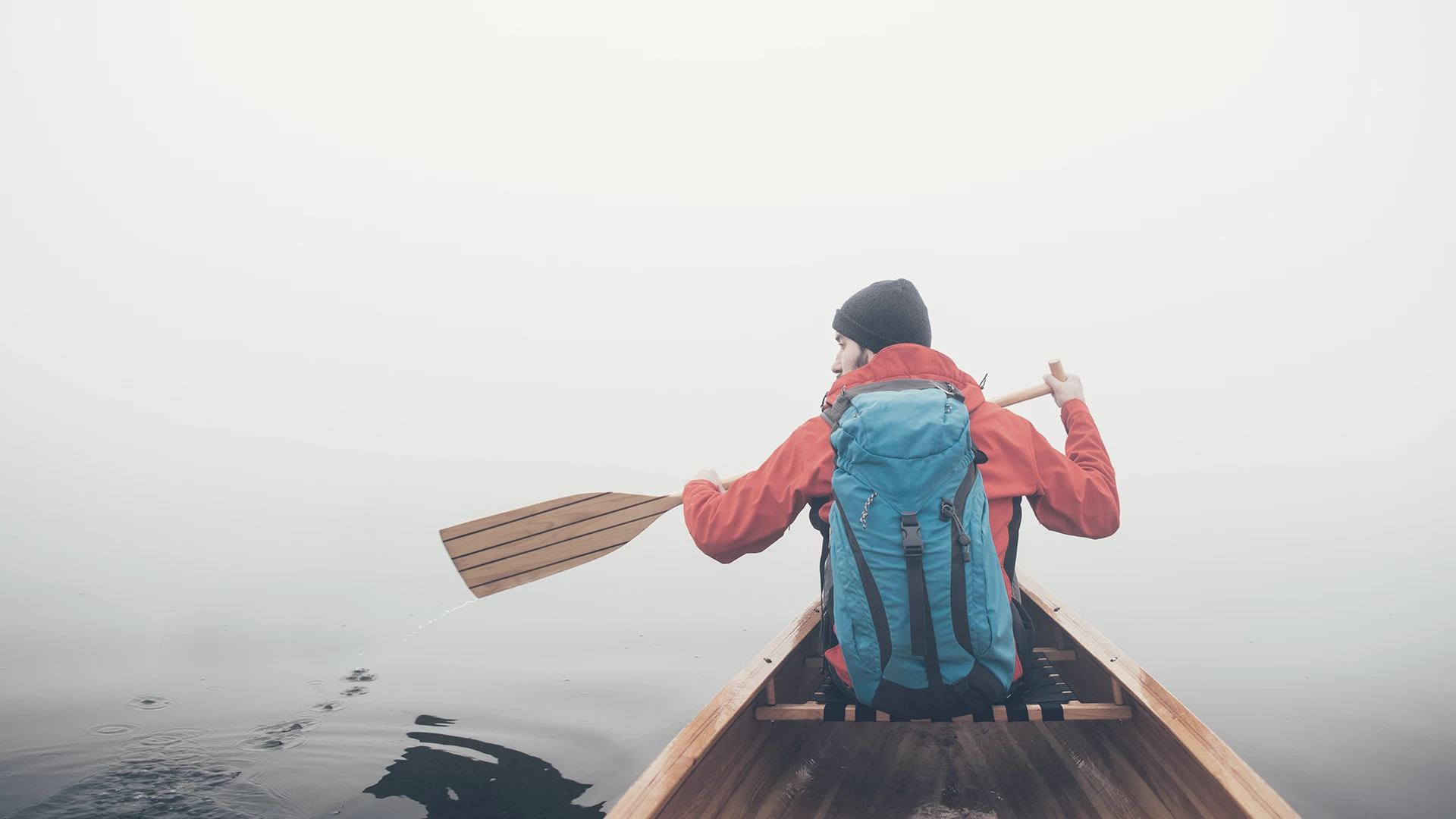 Man canoeing in a foggy weather