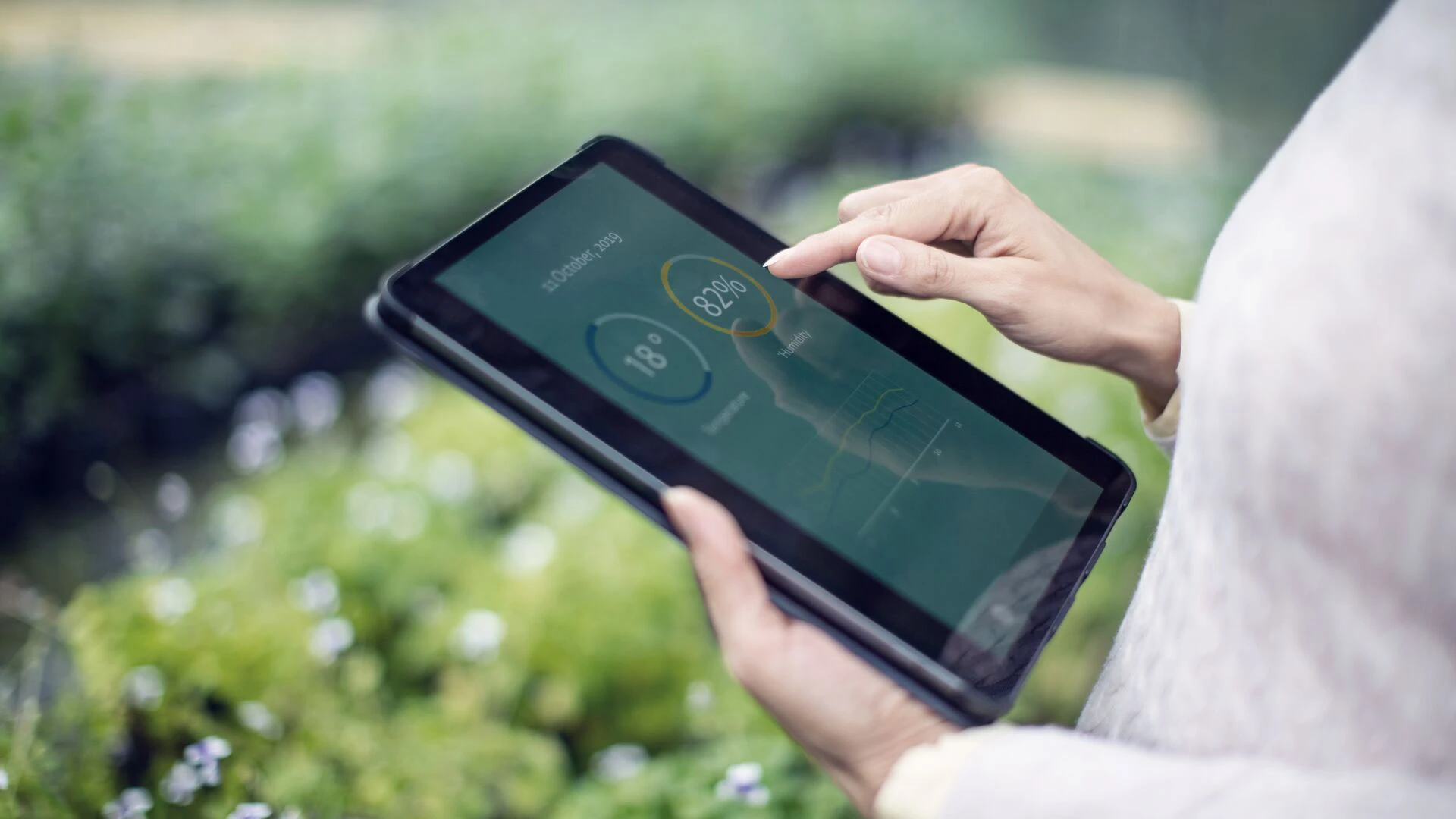 Gardener using digital tablet for information about new plants