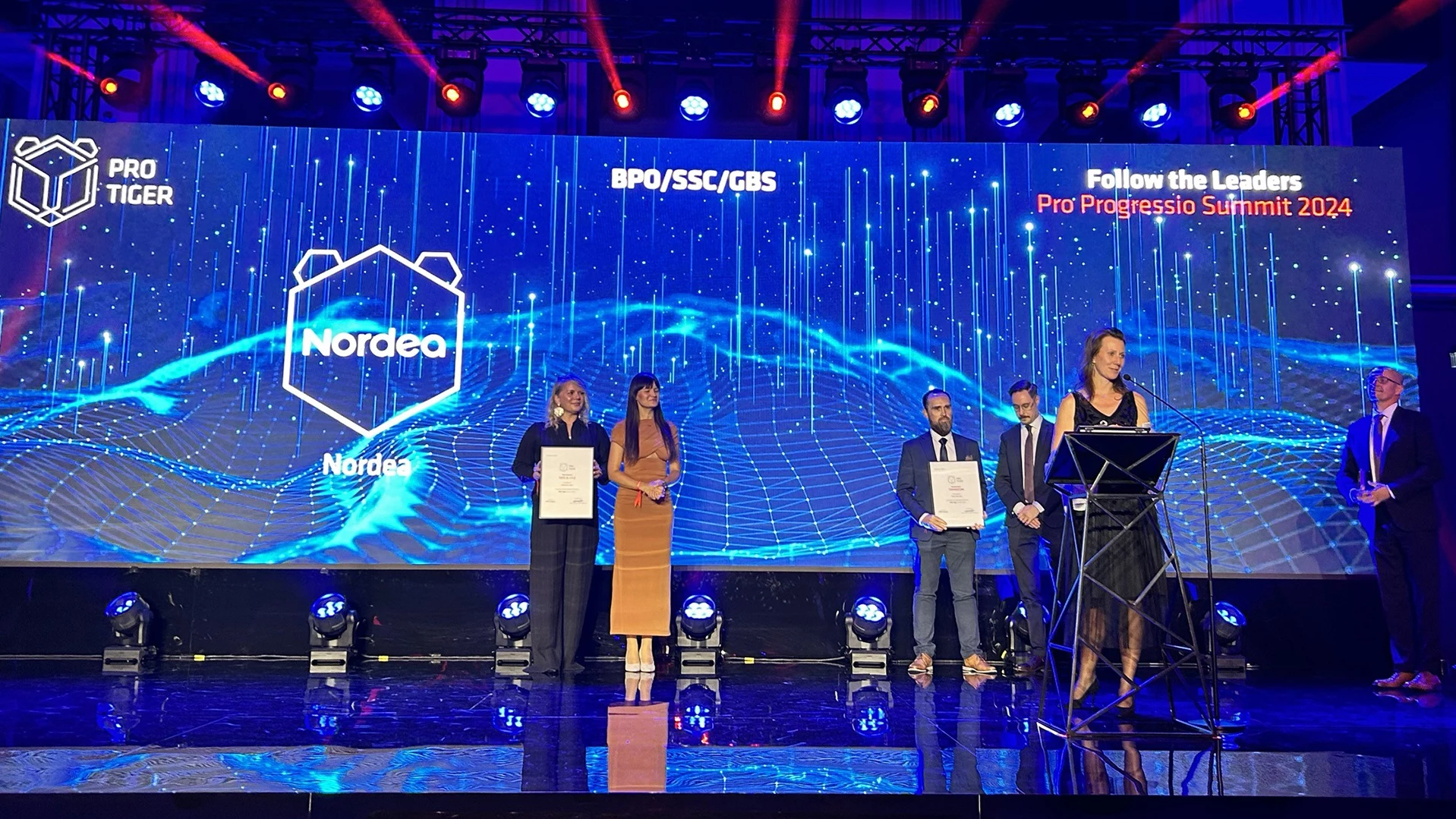 people on stage receiving an award
