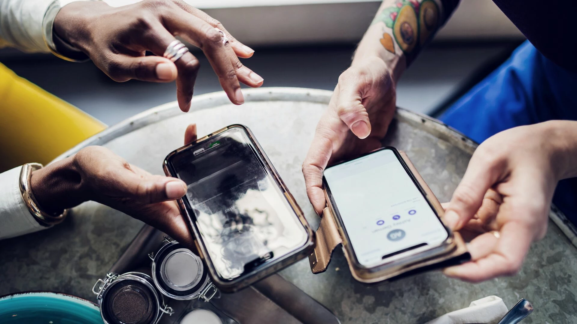 Friends sending money to each other using smart phones
