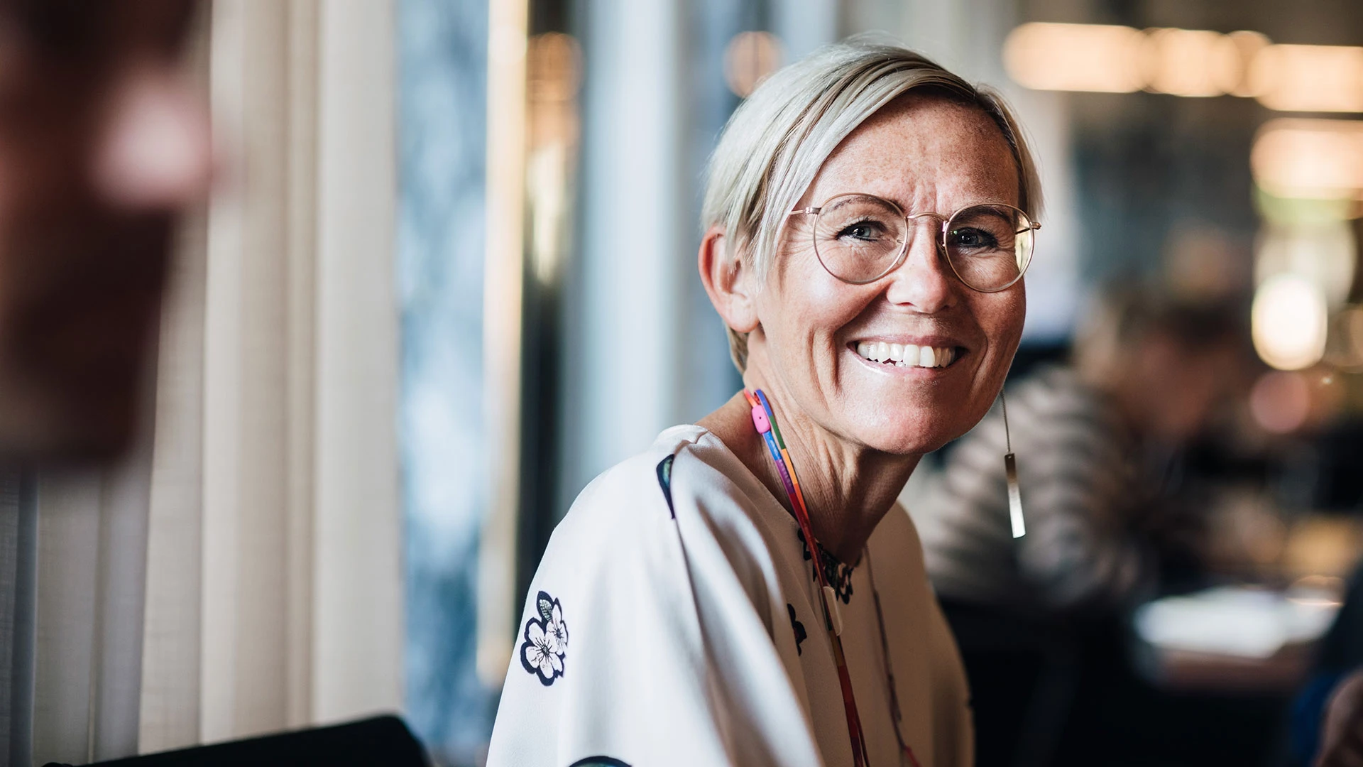 Senior smiling business woman in cafe