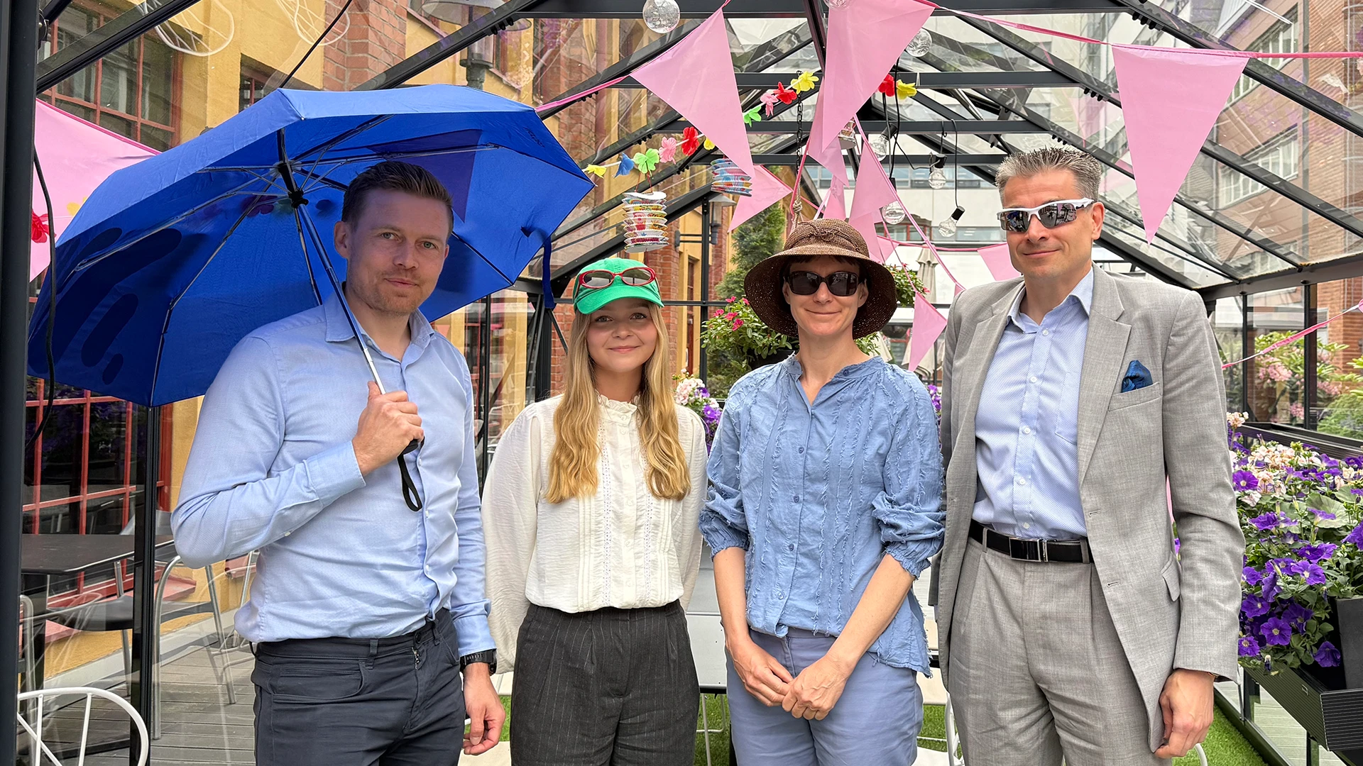 Juho Kostiainen, Jade Halme, Tuuli Koivu and Jan Von Gerich outside wearing sunglasses and smiling.