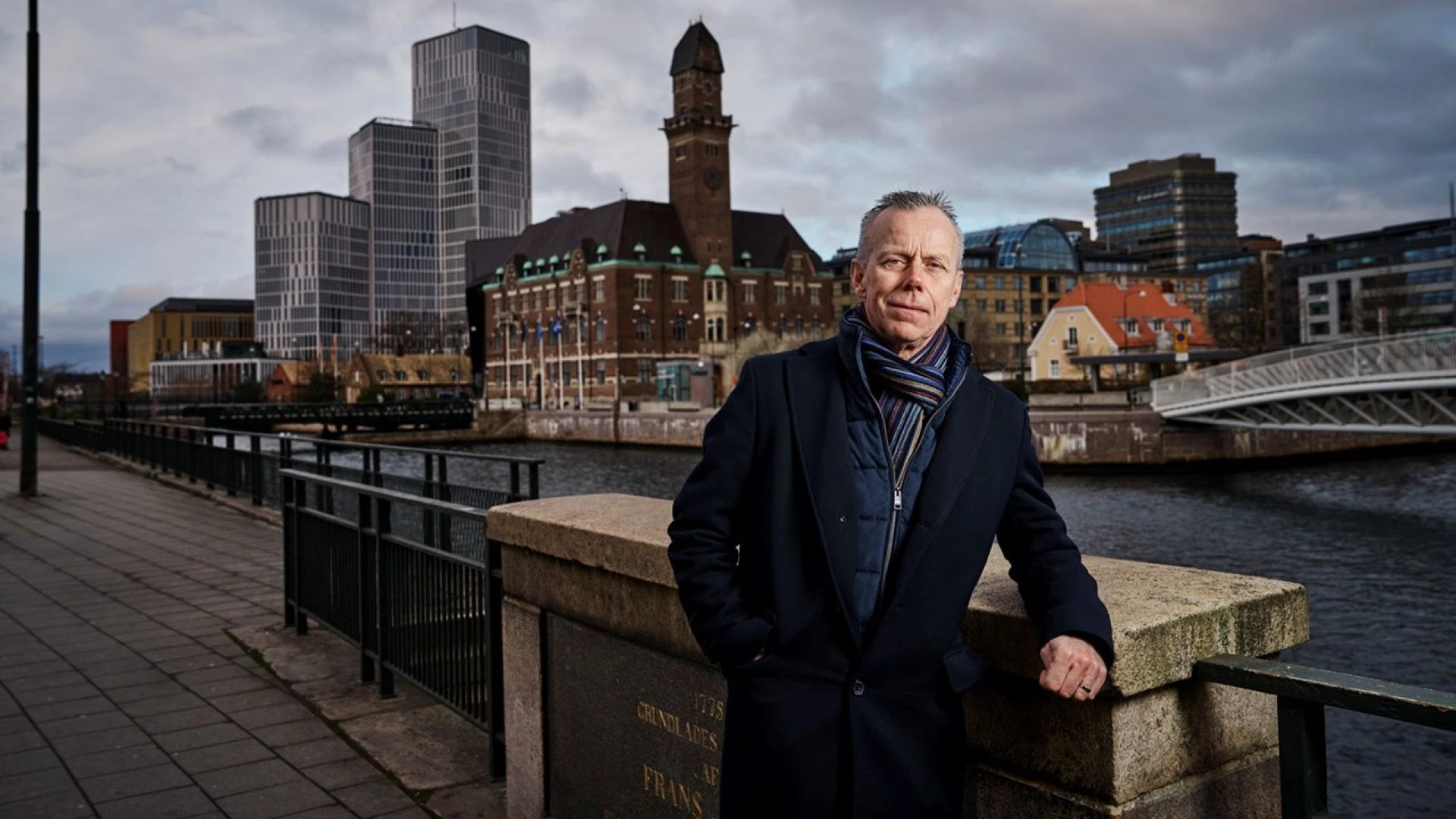 man standing in front of a city skyline