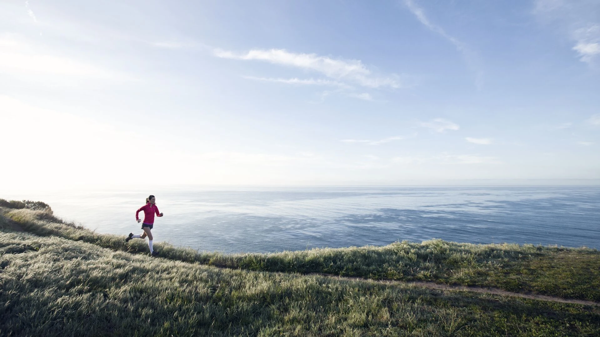 Woman trail running near the ocean