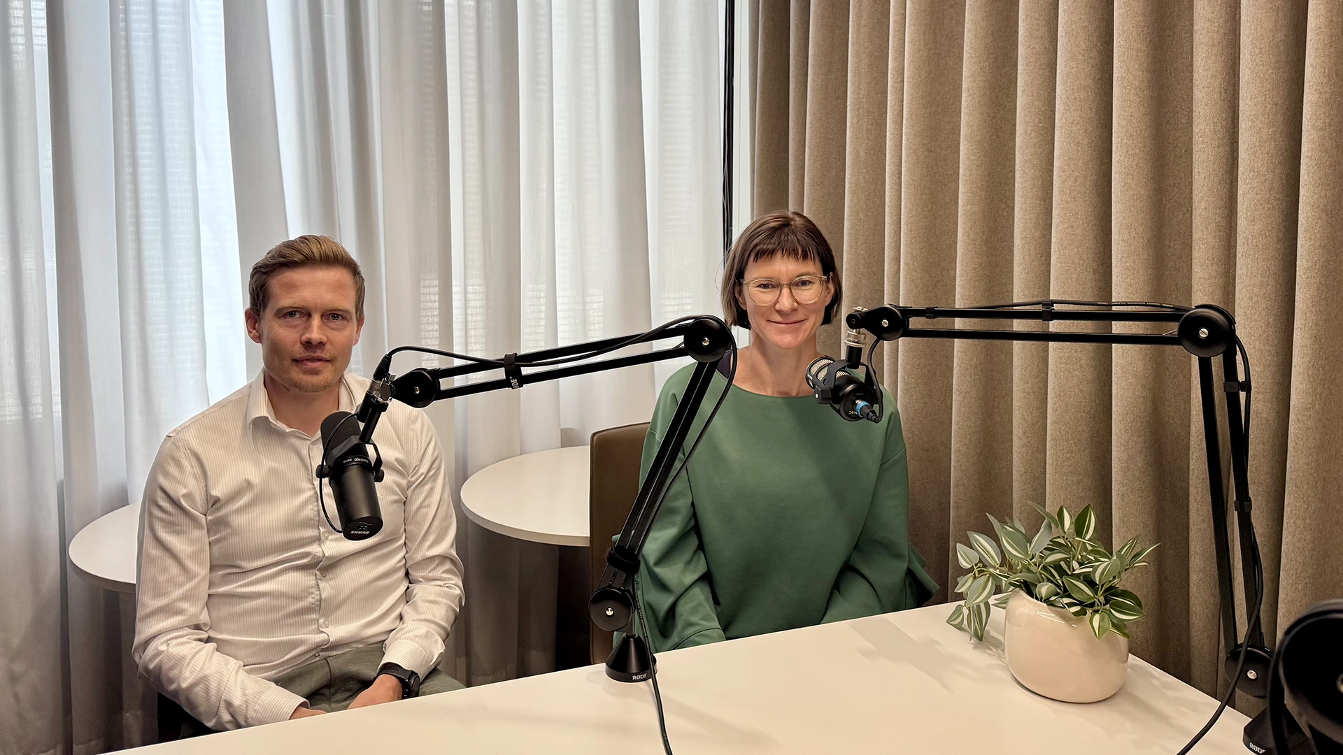 Juho Kostiainen and Tuuli Koivu in a podcast studio