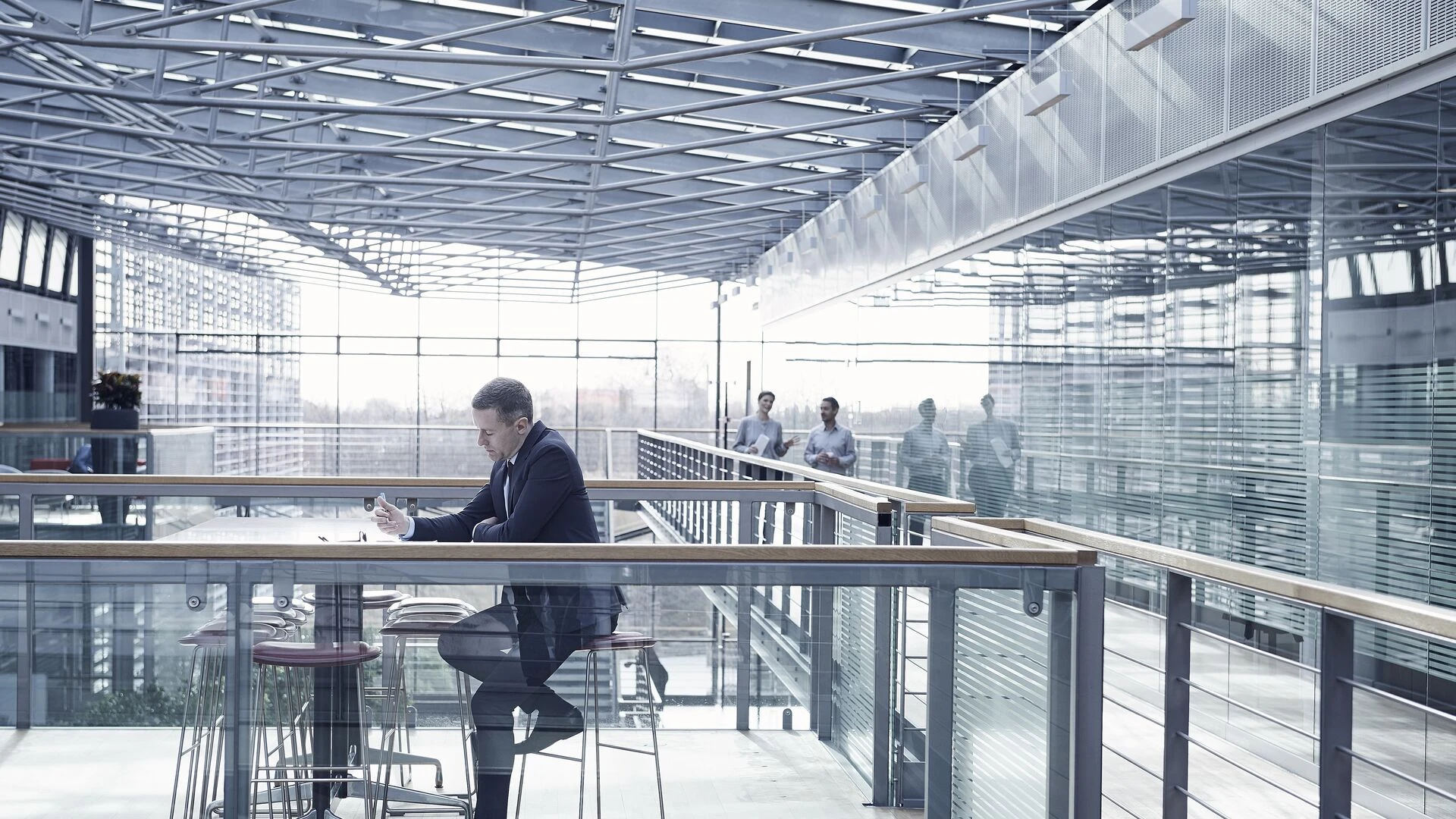 Businessman doing paperwork sitting at office balcony table