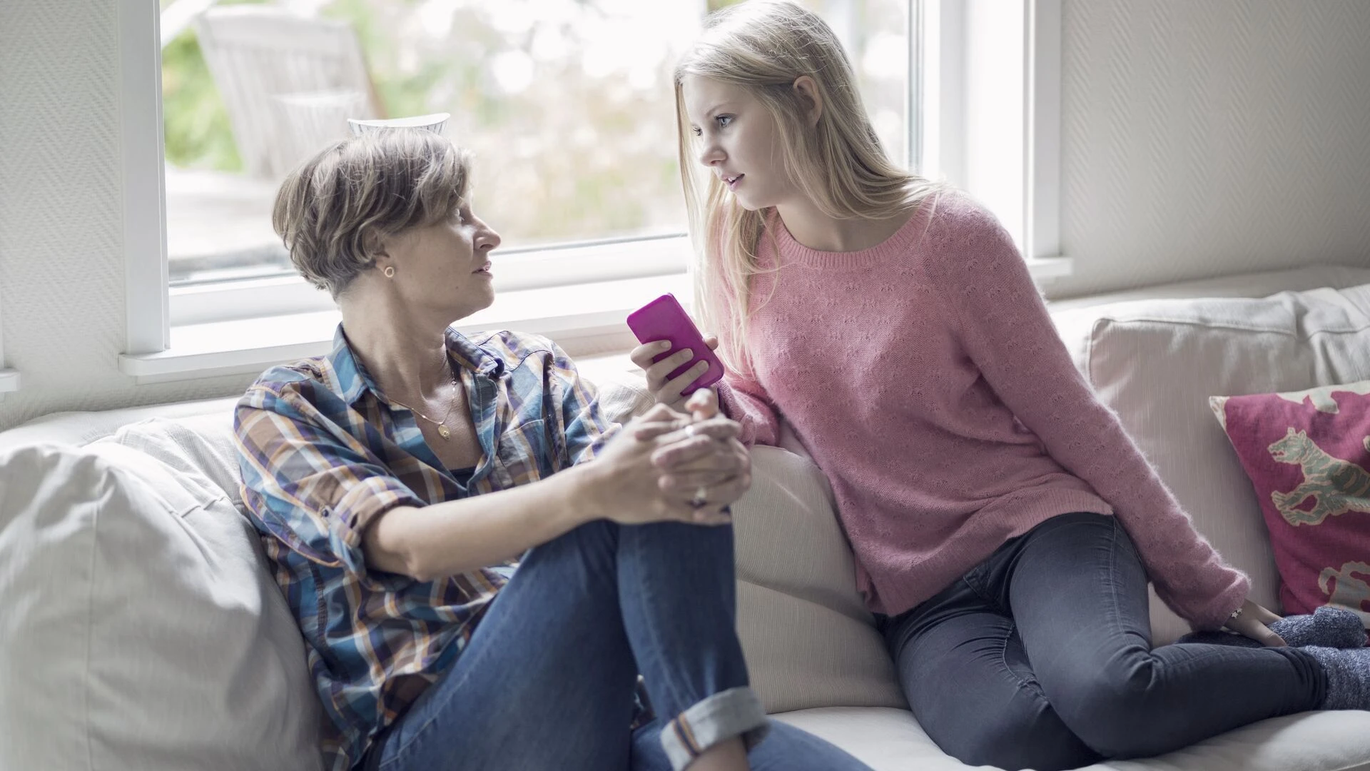 Morher and daugther conversing in living room