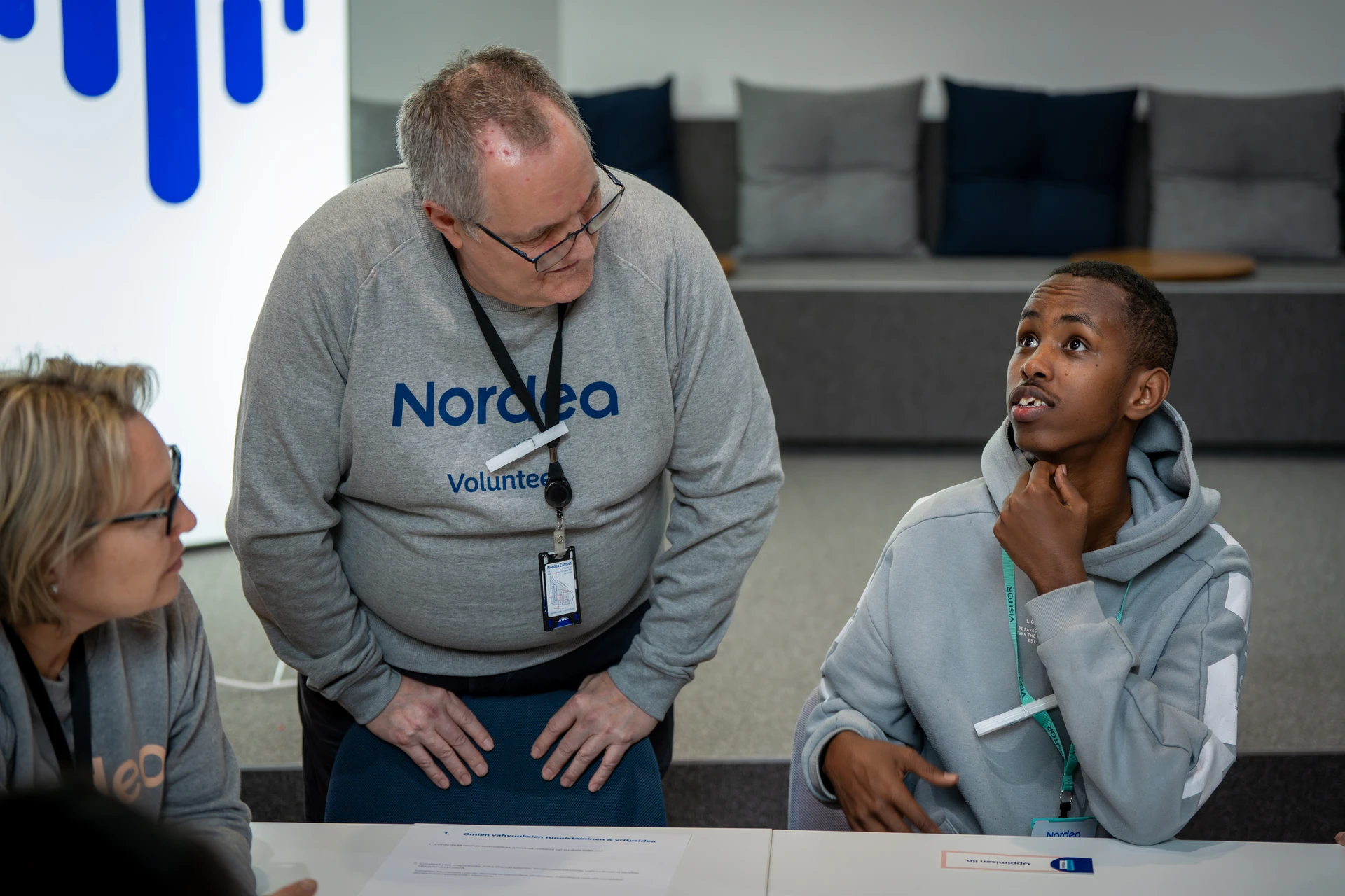 Three people discussing around the table  