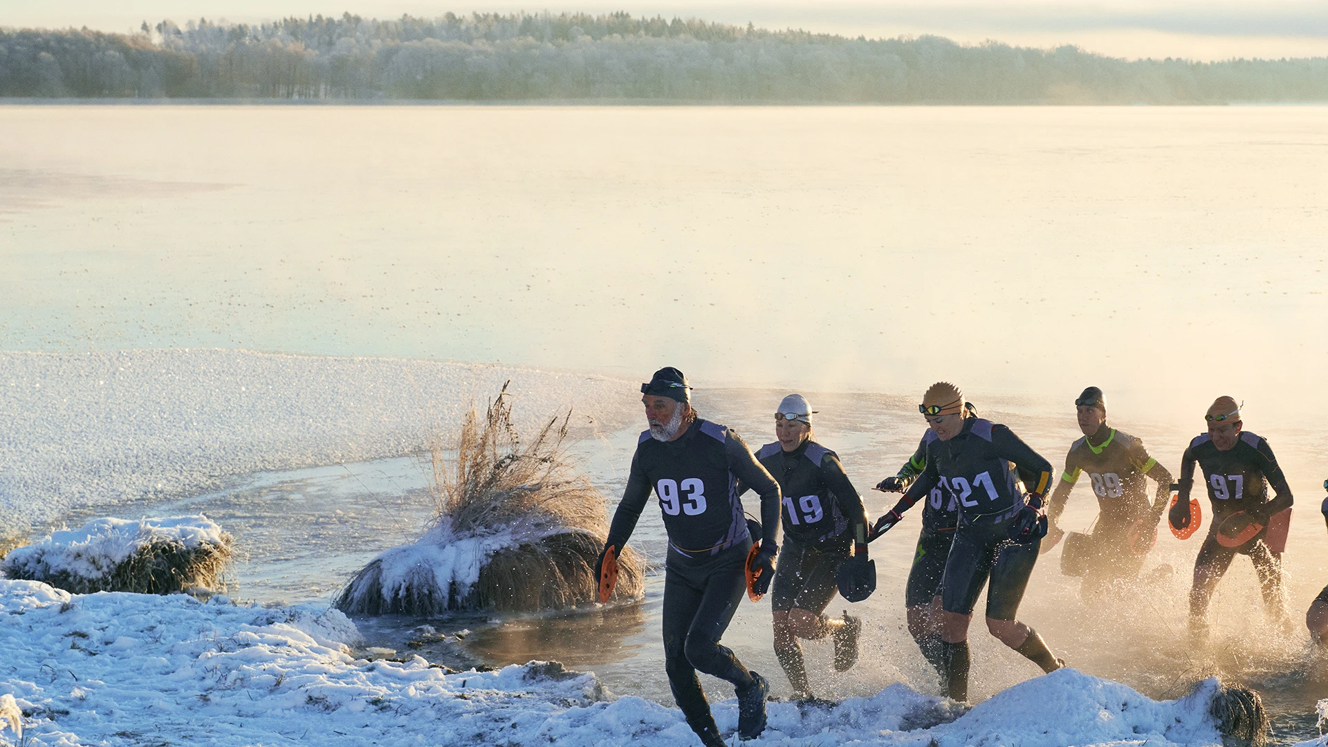 /Group%20of%20ice%20swimmers%20running%20up%20from%20the%20lake.
