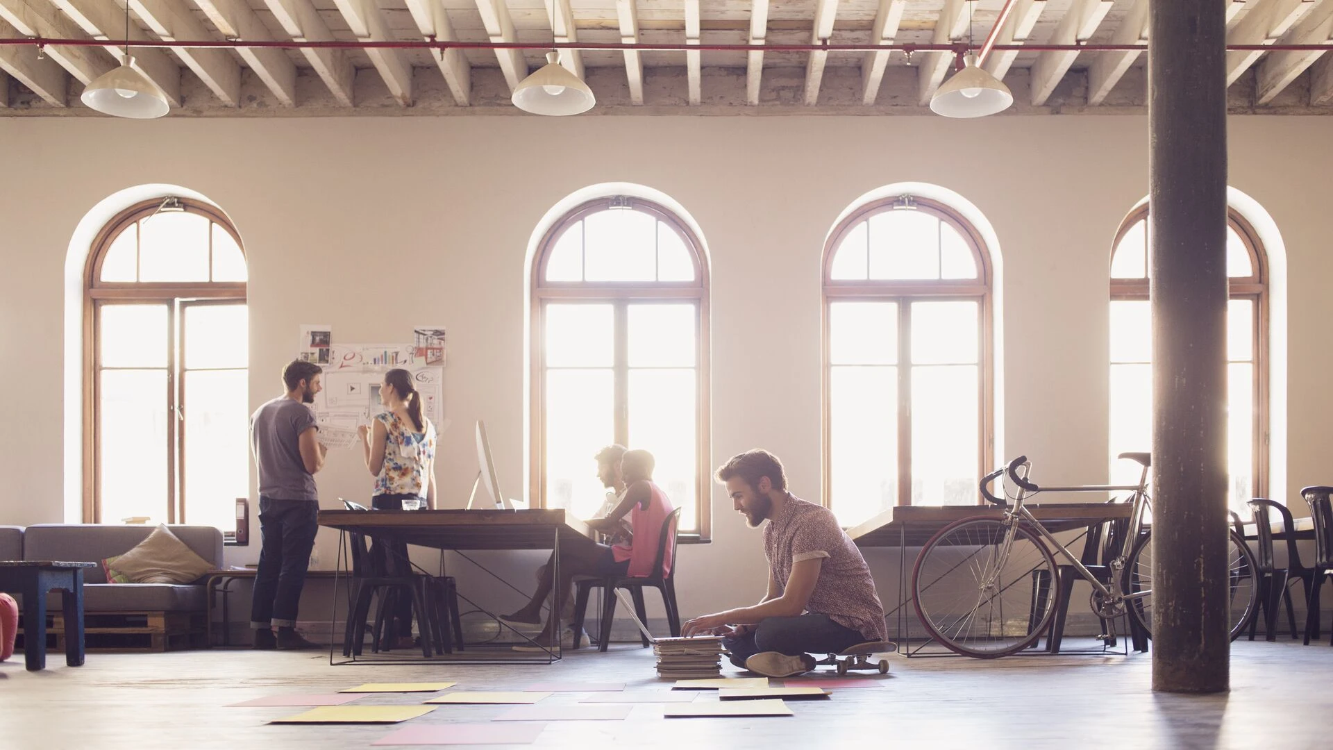 /businessman-on-skateboard-working-at-laptop.