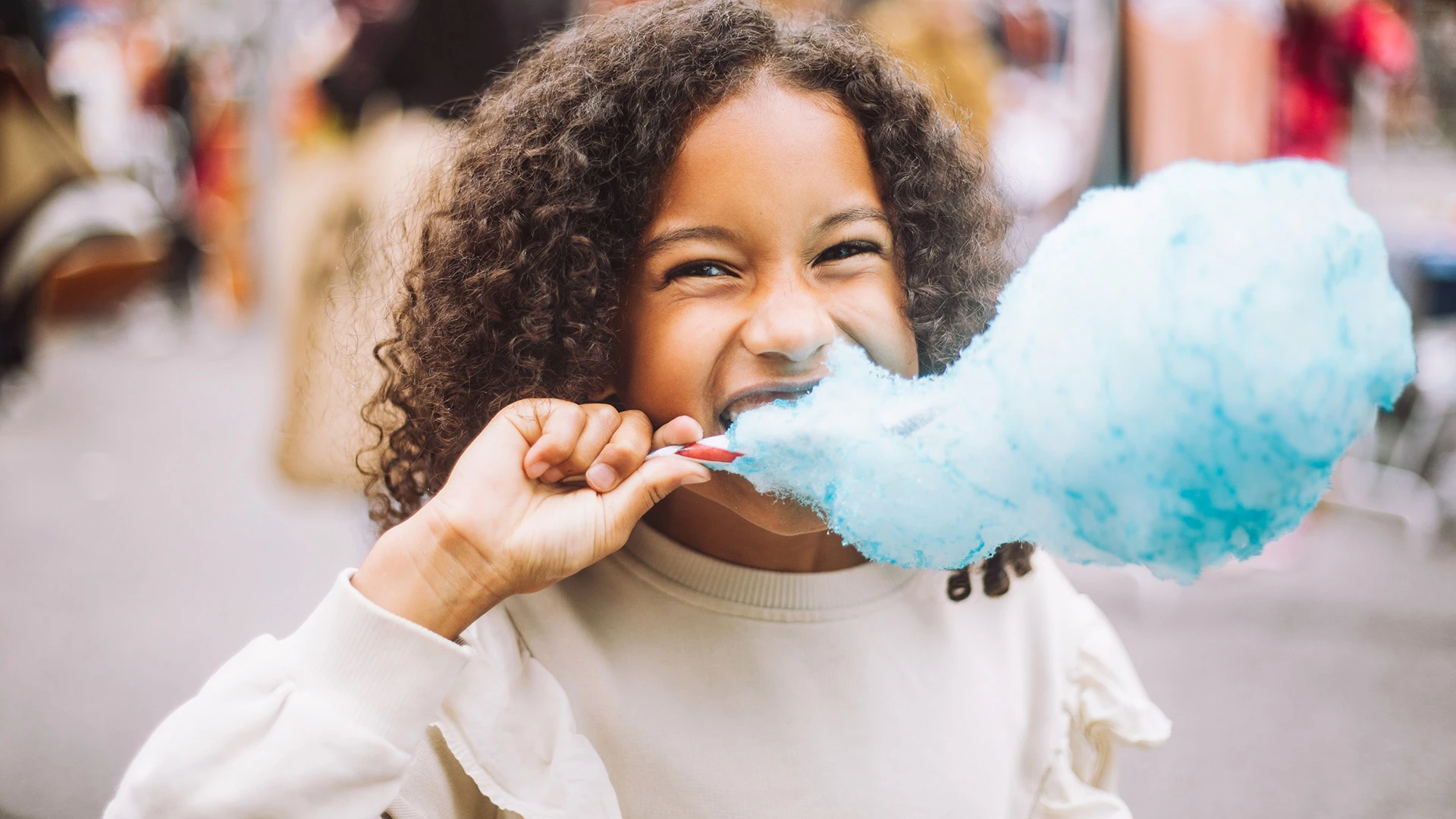 kid eating cotton candy