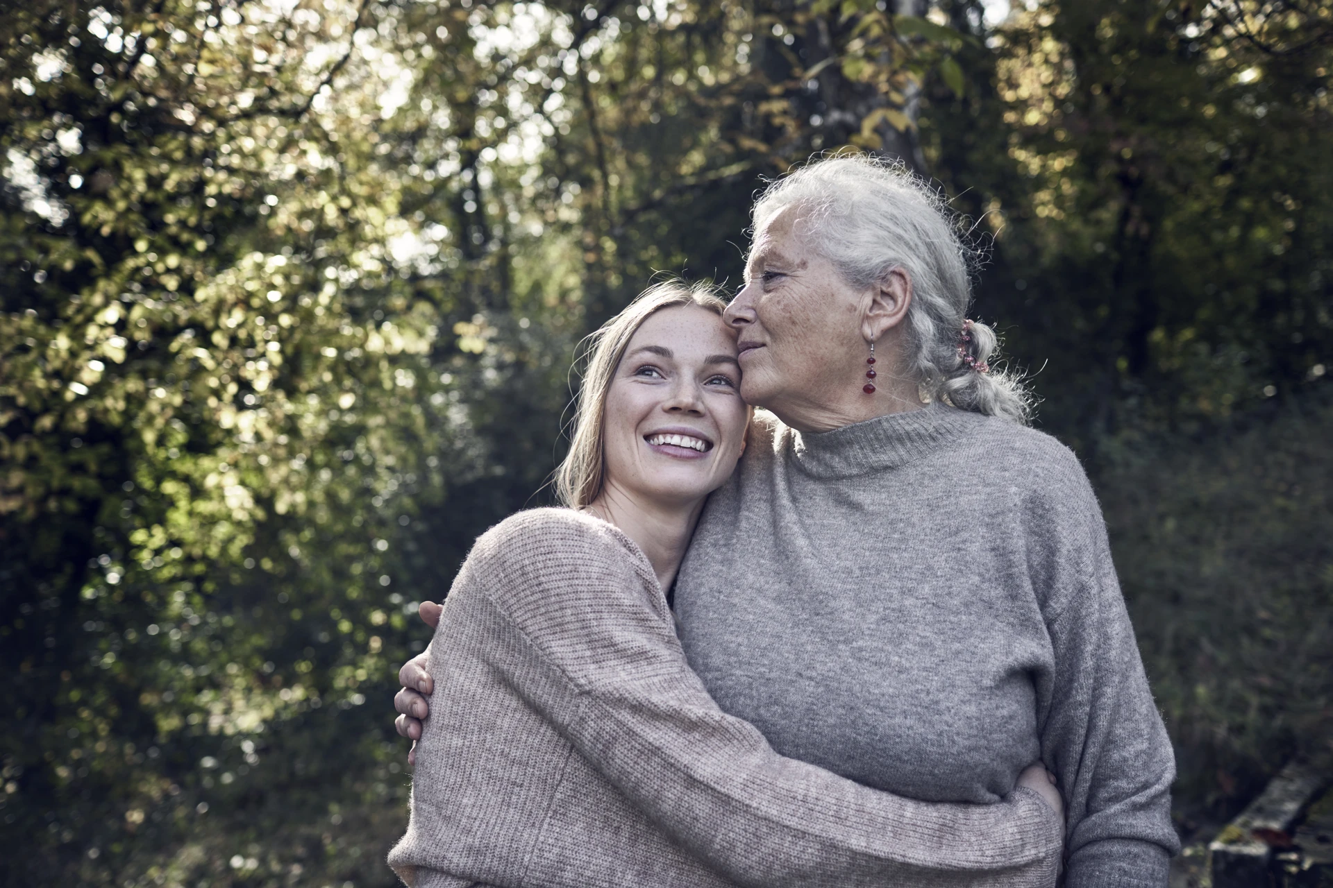 Adult daughter hugging her old mother