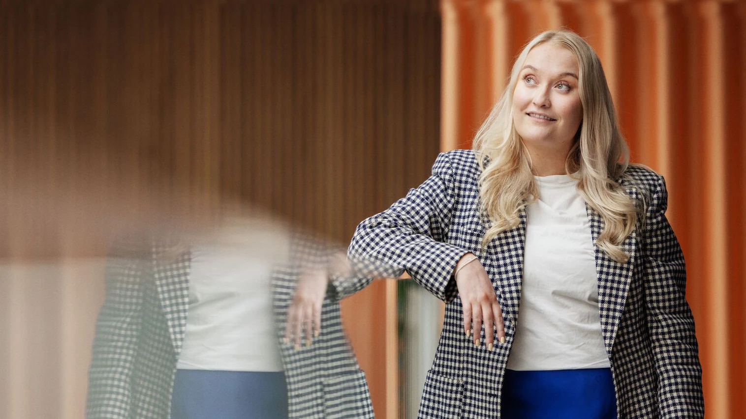 /Junior%20women%20standing%20gazing%20with%20a%20smile%20in%20corporate%20environment..