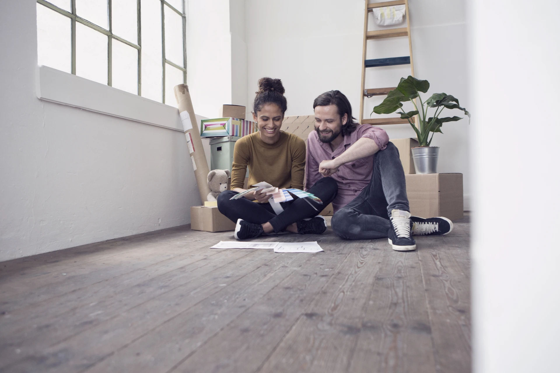 couple sitting on floor with paintsamples