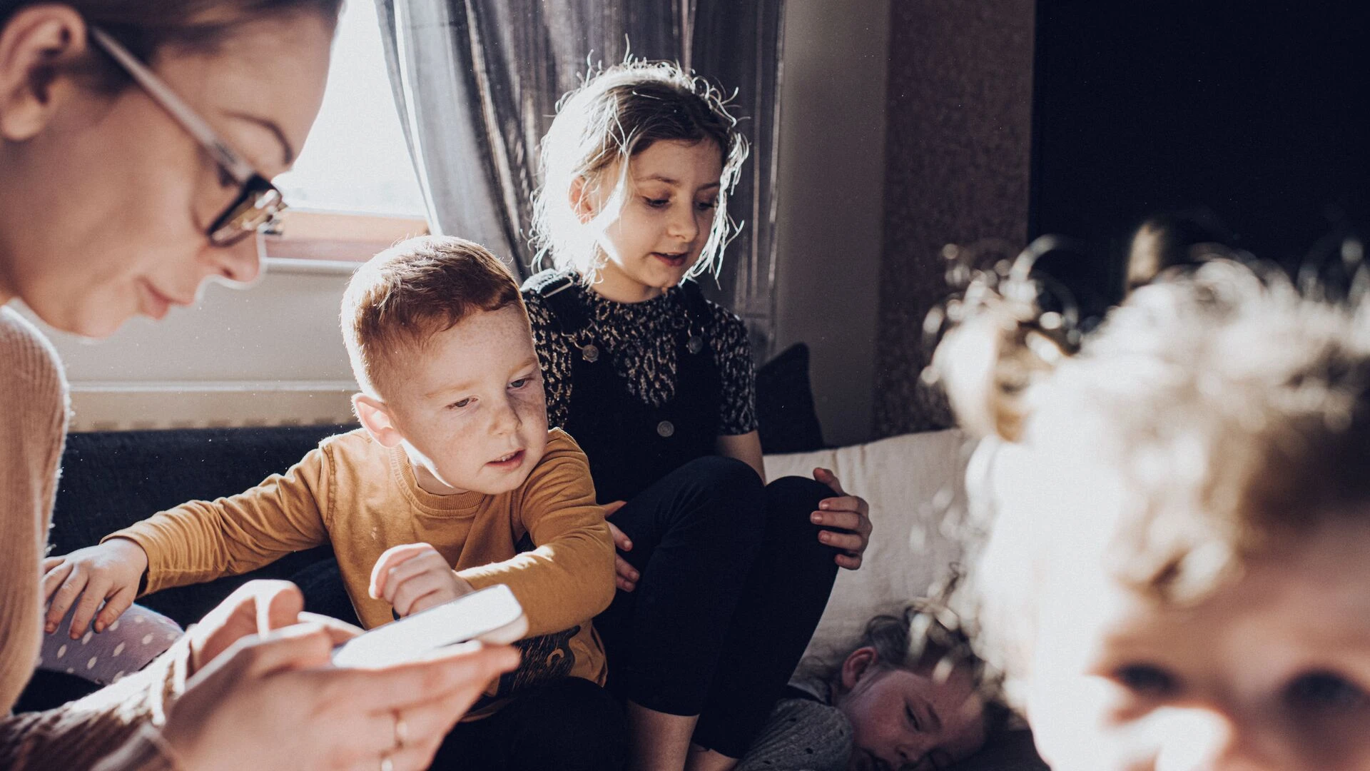 Mother attempts to check phone during chaotic family life