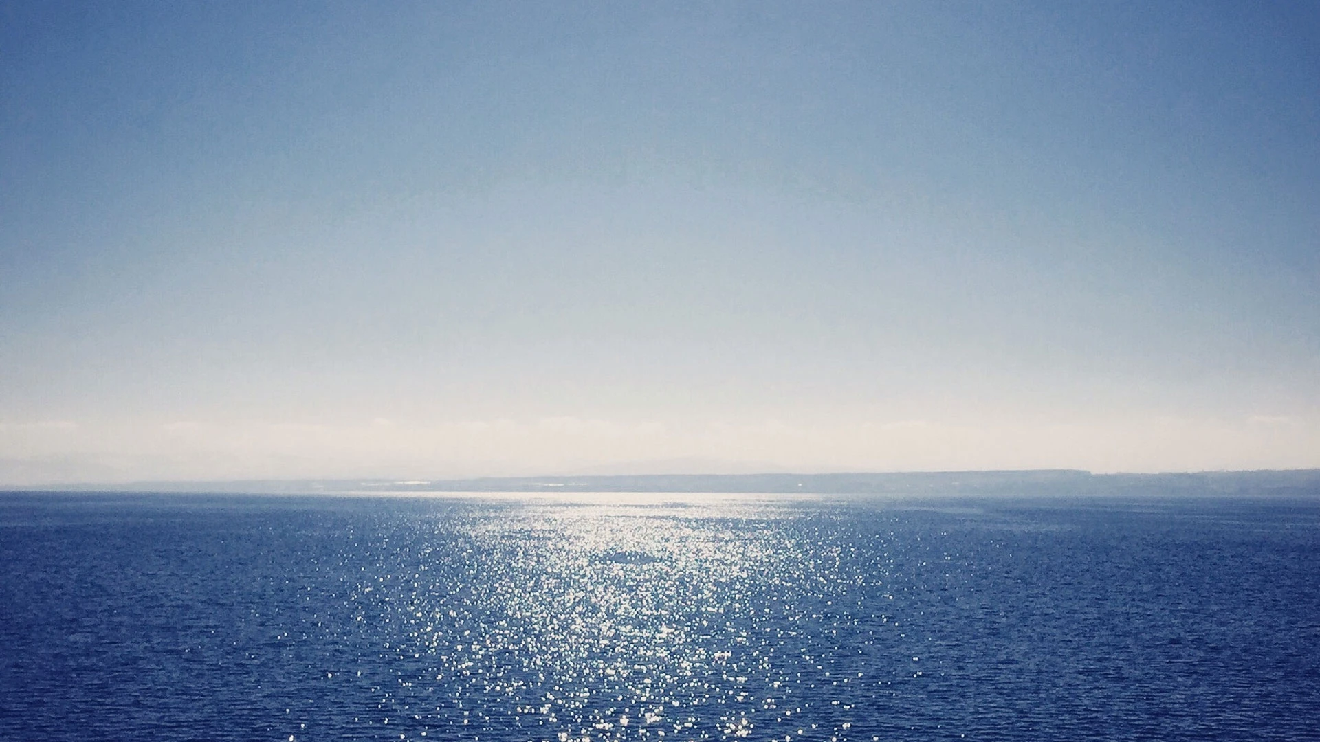 Sea against clear blue sky