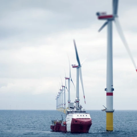Windmills and tanker in open sea