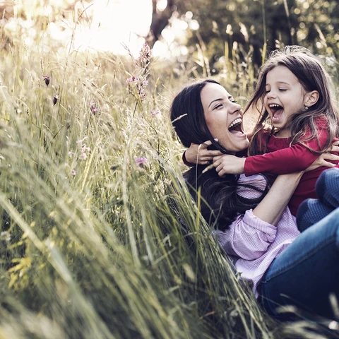 happy mother and child in a field