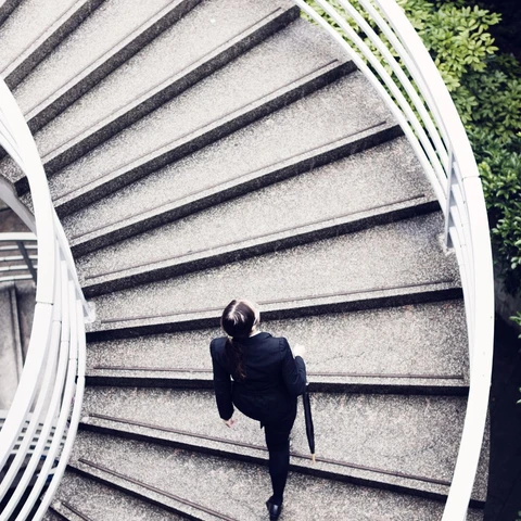 Business woman walking up some stairs