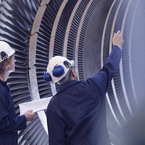 Engineers looking at turbine