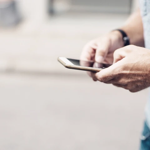 Close-up of man holding phone