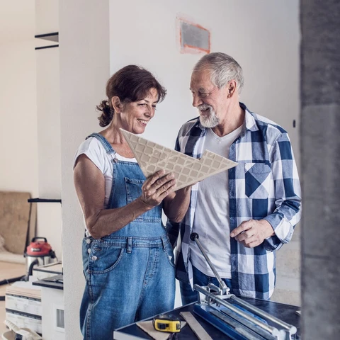 senior-couple-laying-tile-floor-in-new-home