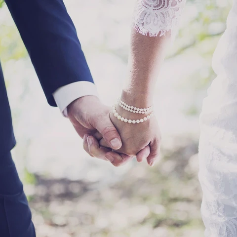 newly-married-couple-holding-hands