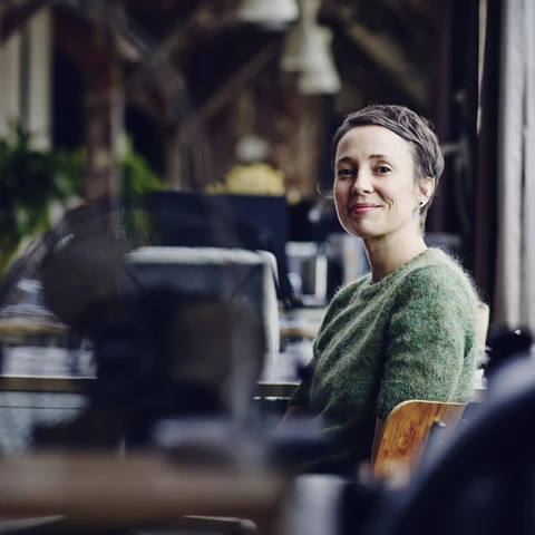 Smiling woman sitting at a desk in modern office