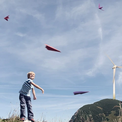 boy-playing-with-paper-planes
