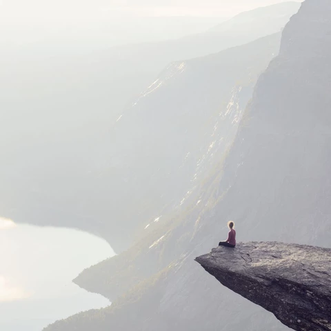 woman-sitting-on-the-edge-of-a-cliff-flipped.