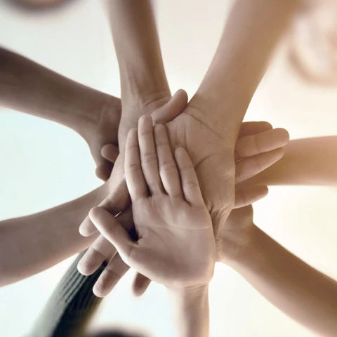 Hands joining together and showing teamwork