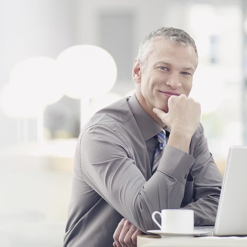 Businessman working on laptop in cafe