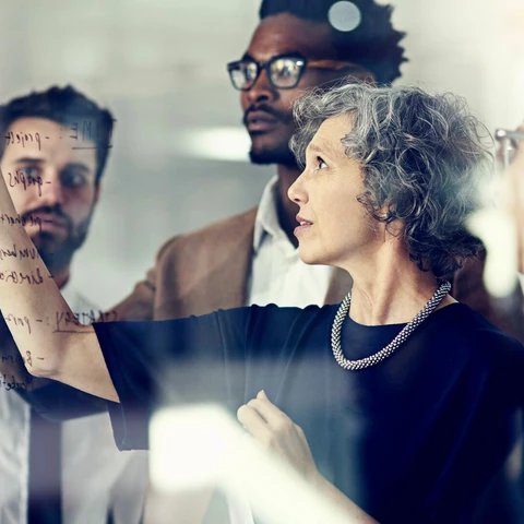 Colleagues in front of glass wall