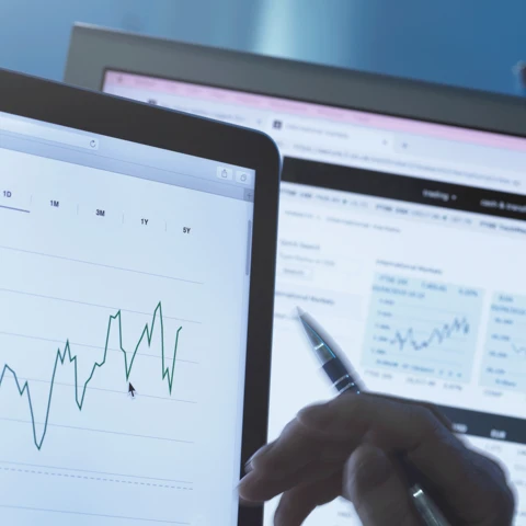 Stock analyst researching share price data graph