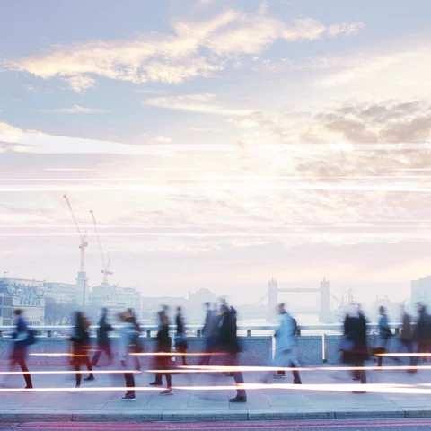 Business-people-walking-through-the-city-at-dawn